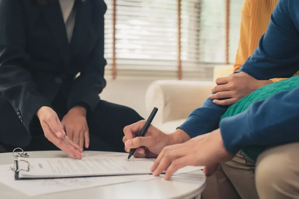Homeowner signing documents for a private home equity loan in British Columbia